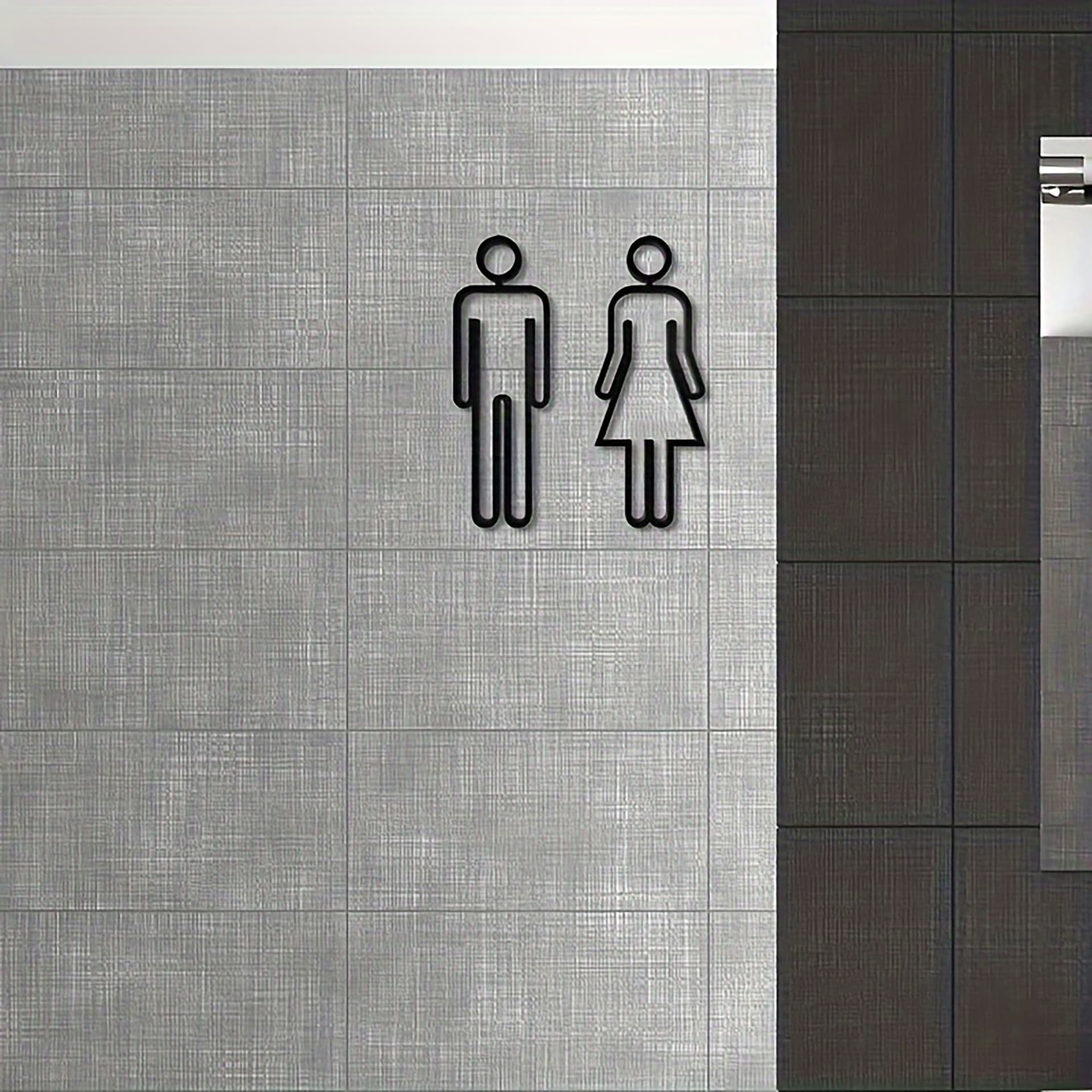 One set of durable black matte acrylic bathroom signs for men's and women's restrooms in hotels.
