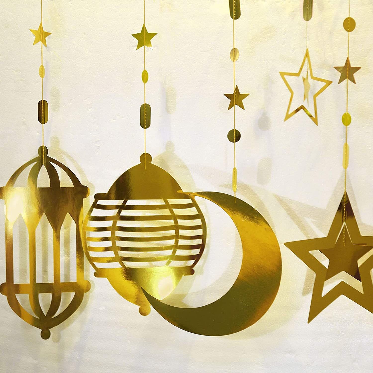 Lanterns, stars, moons, hanging ornaments, plain laser-cut silver paper strings, garlands, shop window decorations, hotel lobby decorations