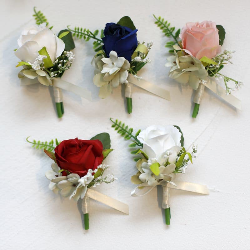 Wedding corsages for grooms and best men, artificial roses for brides and bridesmaids, wedding wrist corsages, and floral wrapping decorations.