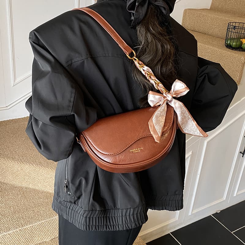 Custom processing vintage saddle bag with wide shoulder strap, commuting single shoulder bag, stylish chain and scarf accessory crossbody bag for women.