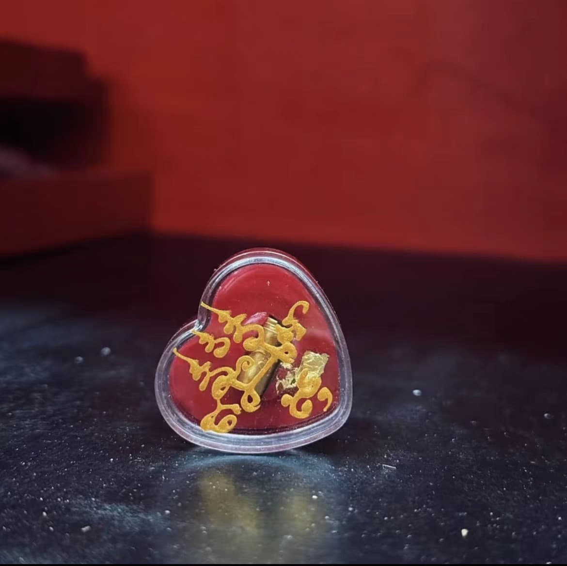 Thai specialties: Phra Phrom (sticky paste), red takrut (amulet), blessed.