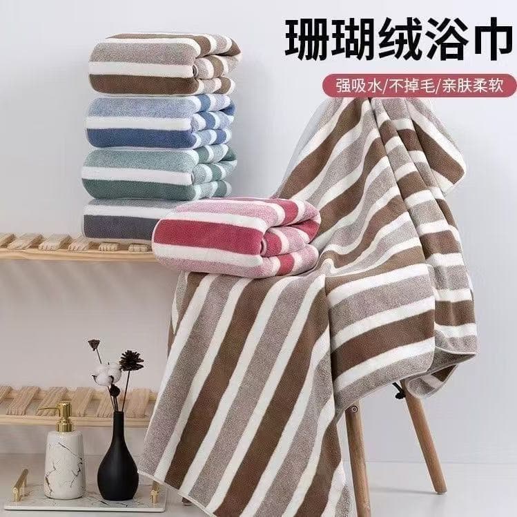 Wholesale warp-knitted stripe coral fleece bath towel 70*140, extra thick absorbent non-shedding gift wholesale home large bath towel.