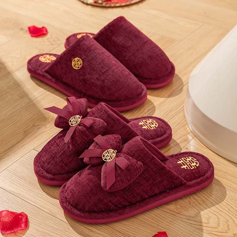 A pair of red wedding slippers for winter, featuring a light luxury style for newlyweds, festive bridal dowry slippers with a premium feel.