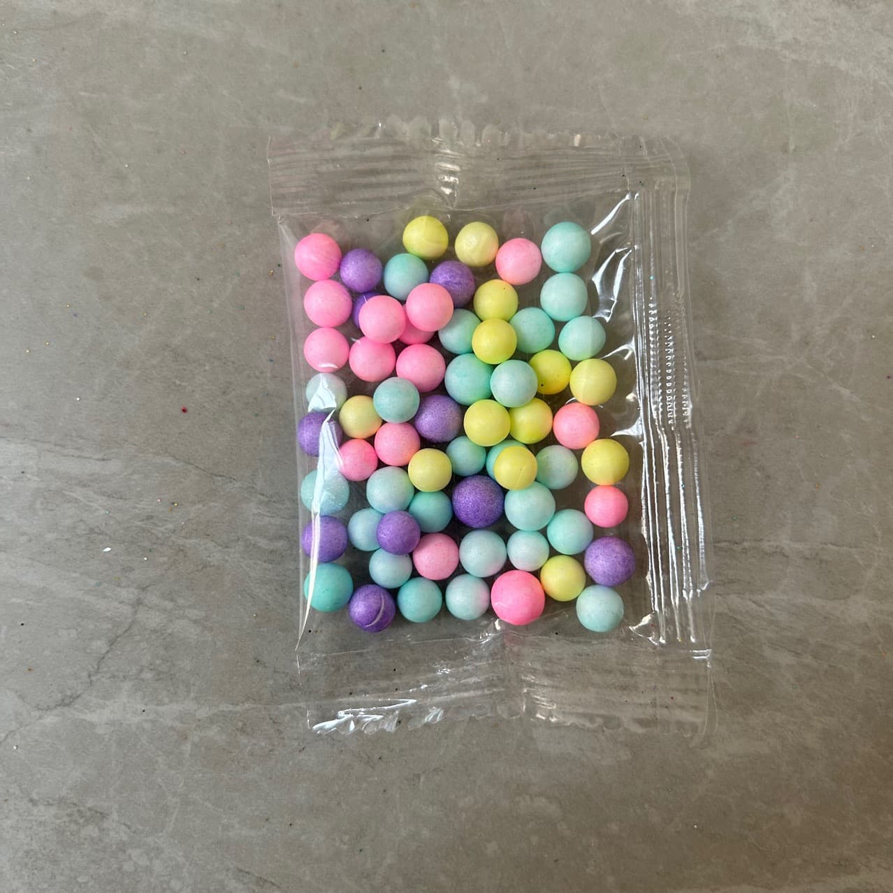 Small packets of large-particle macaron-colored foam balls for DIY colorful slime crafting accessories.