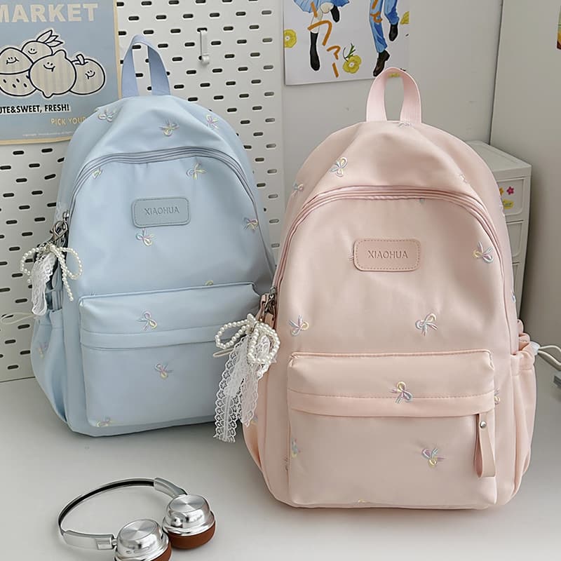 Student schoolbags with bow embroidery, small and fresh, junior high school girls, high-looking, large-capacity backpacks, high school student backpacks