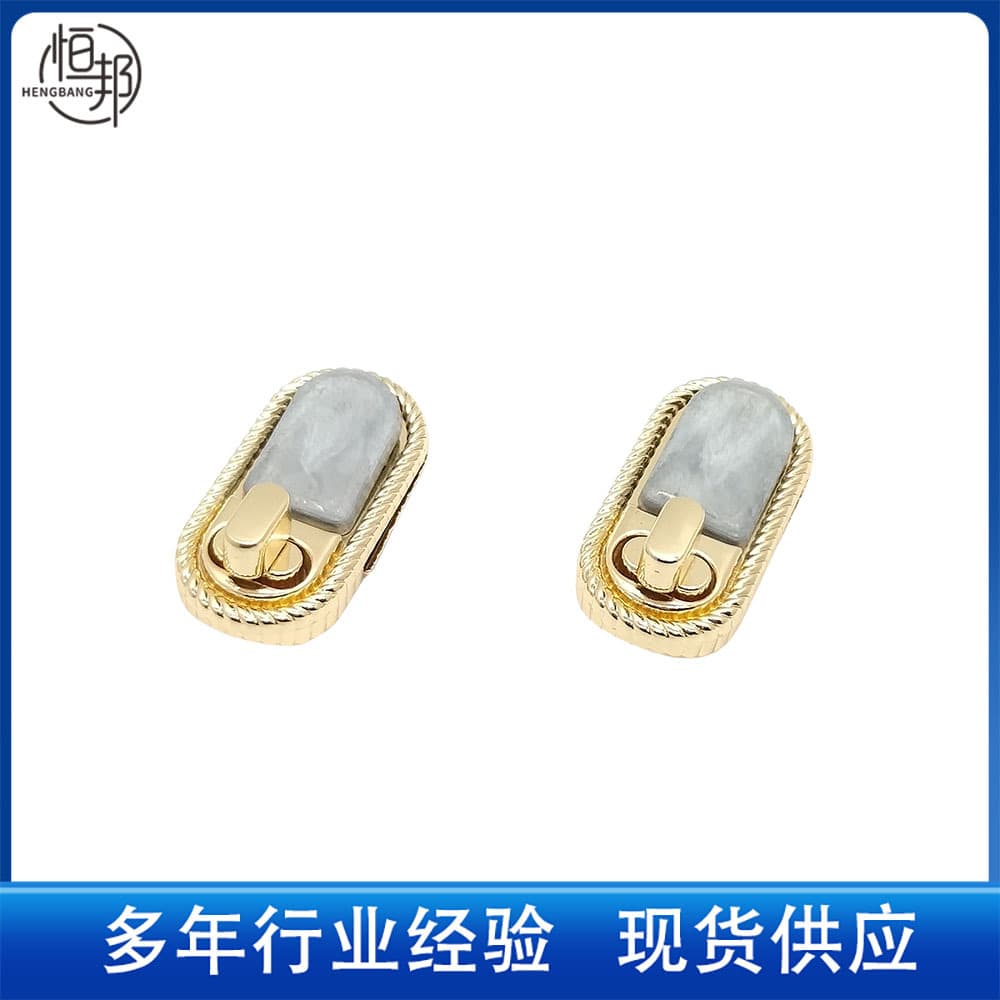 Oval-shaped leather buckles, metal clasps, knobs, and turn locks for bags and luggage. Available for wholesale from the manufacturer.