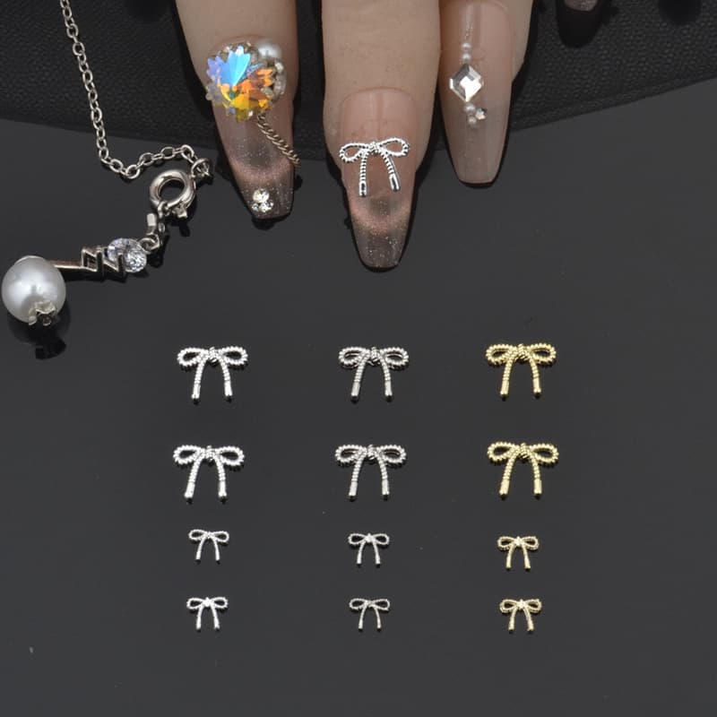 Nail art alloy decorations, 3D bows, tie ribbons, metal alloy nail tools, nail stickers, rhinestones.