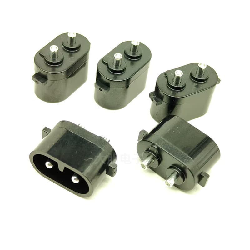 Small solid two-pin figure-8 AC socket with oval ears for shavers/hand warmers