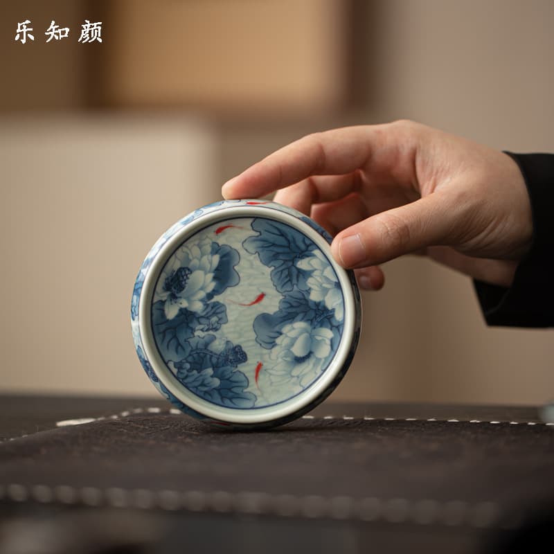Antique-style blue and white lotus and fish-themed lidded teapot and teacup holder, ceramic Kung Fu tea set, retro-style tea brewing accessories for home use.