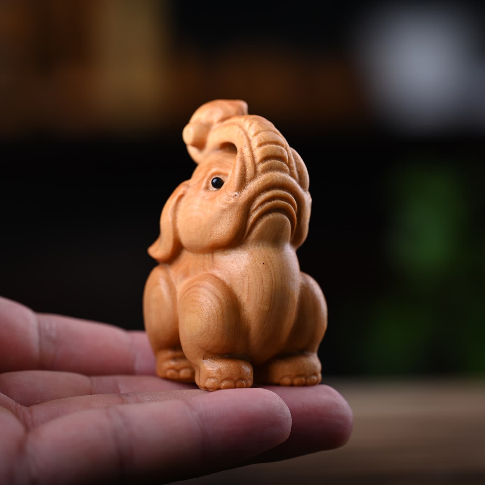 Cliff cypress wood carving, hand-held elephant facing the sky, a symbol of wealth and good fortune, solid wood handicraft, cute wooden elephant cart ornament.
