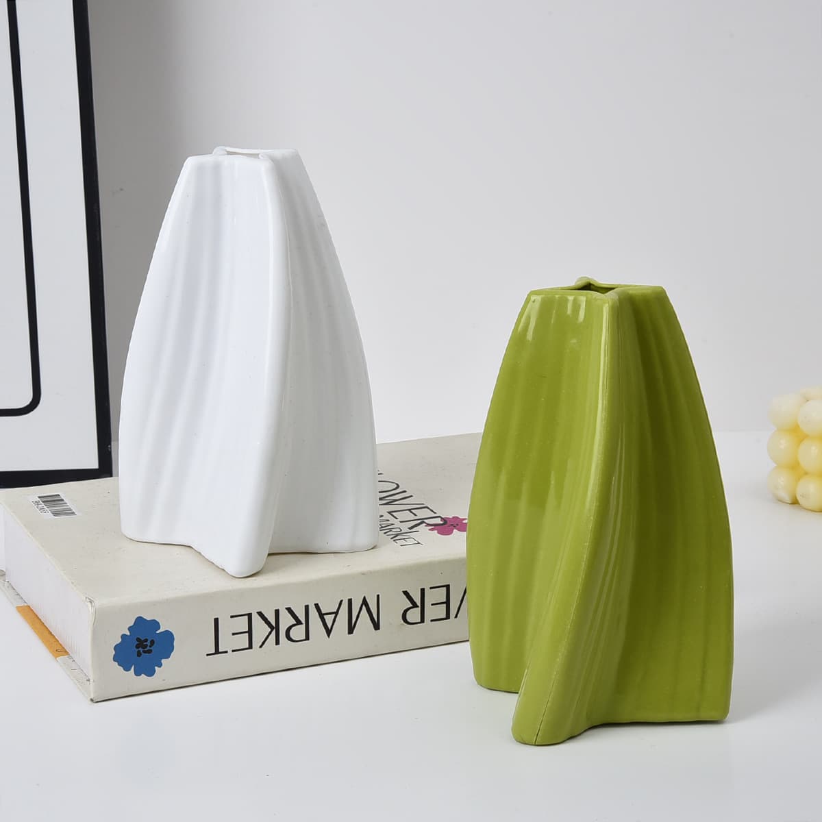 Manufacturer customizes twisty plastic vases; colors and logos can be changed.