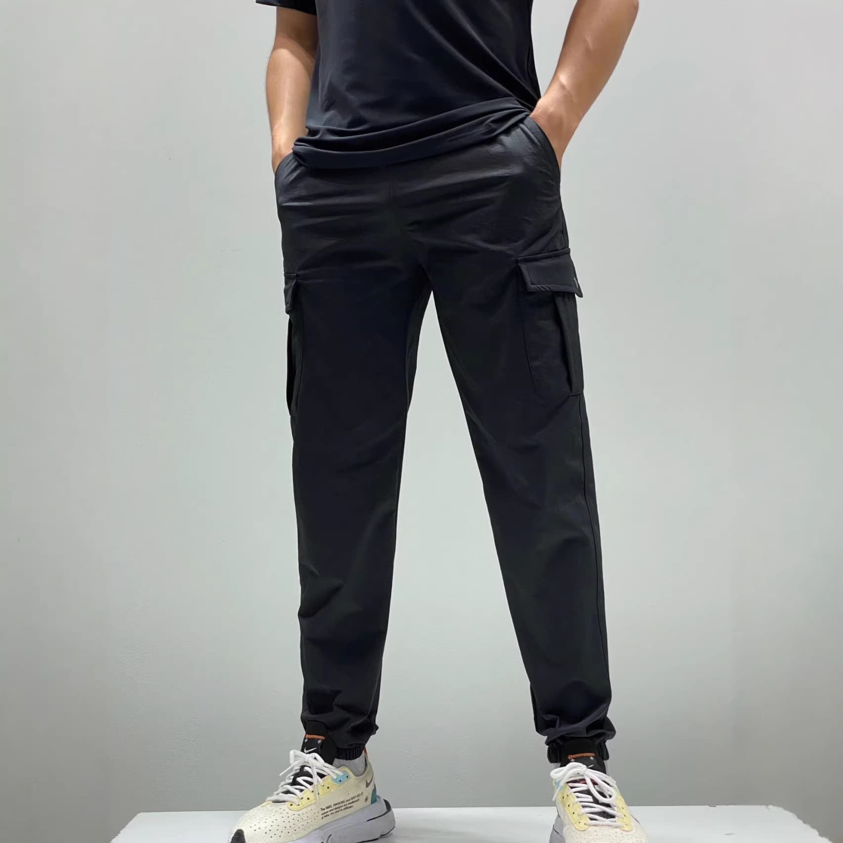 Foreign trade women's classic workwear multi-pocket drawstring design elastic leg casual pants men's style