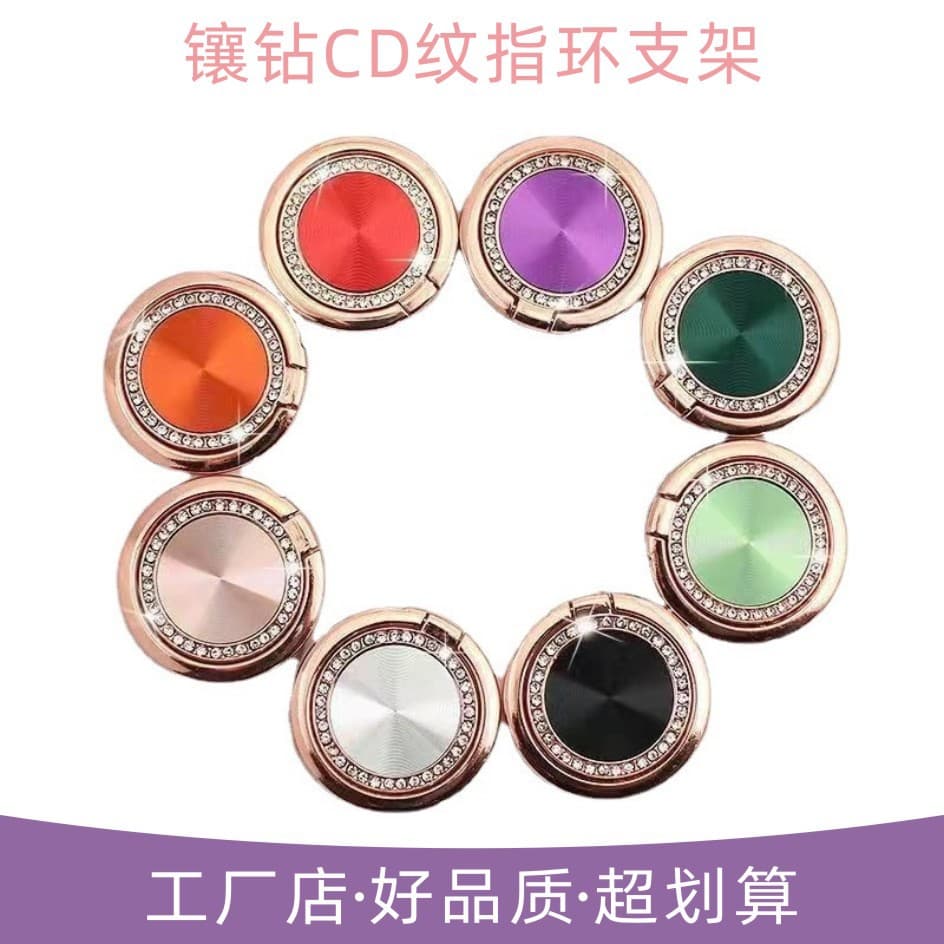 Foldable diamond-encrusted ring holder for mobile phones with CD-patterned metal rings. A desktop essential for wholesale.