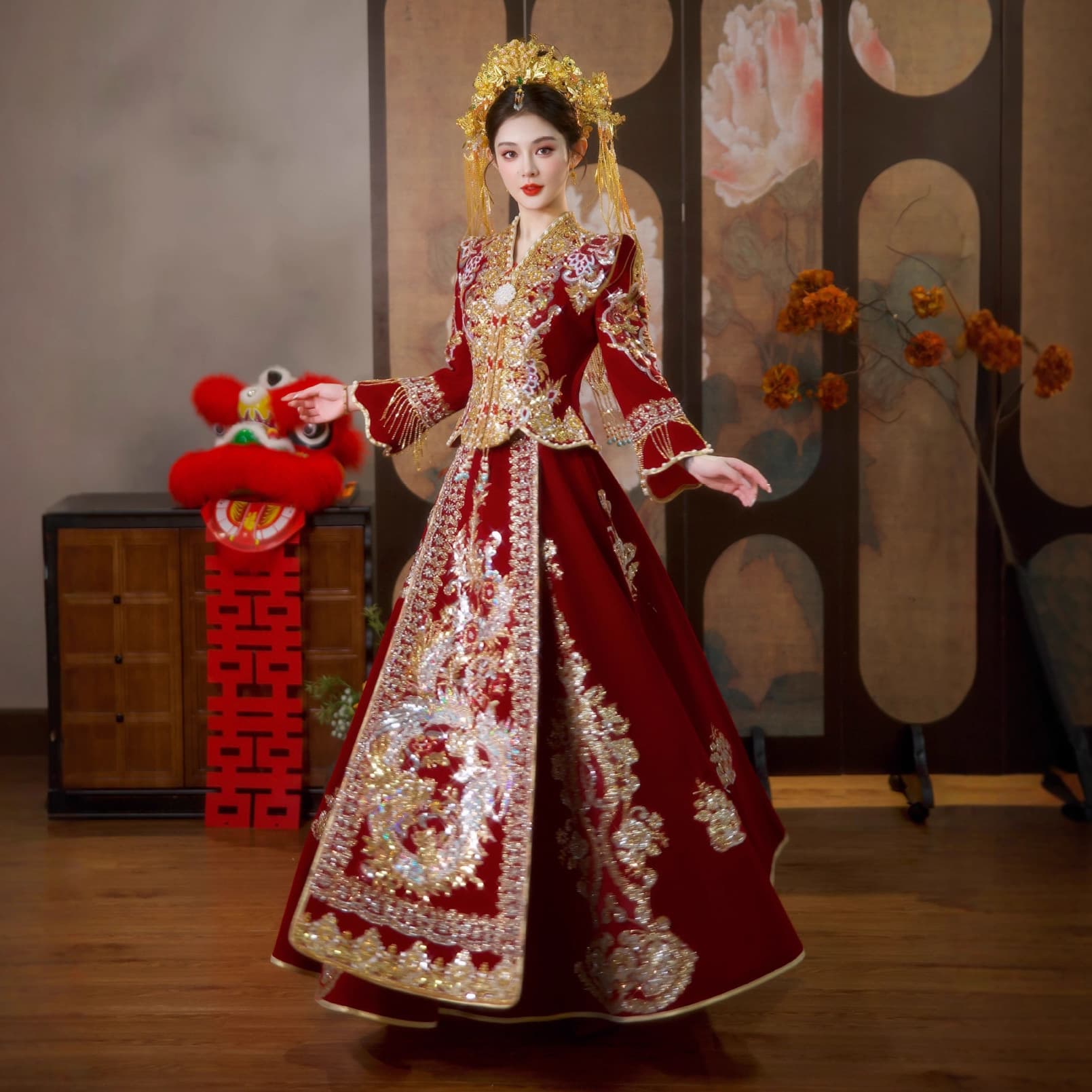 The bride's wedding dress, a fitted and luxurious traditional Chinese wedding gown, complete with a phoenix coronet and embroidered robe, is adorned with brocade.