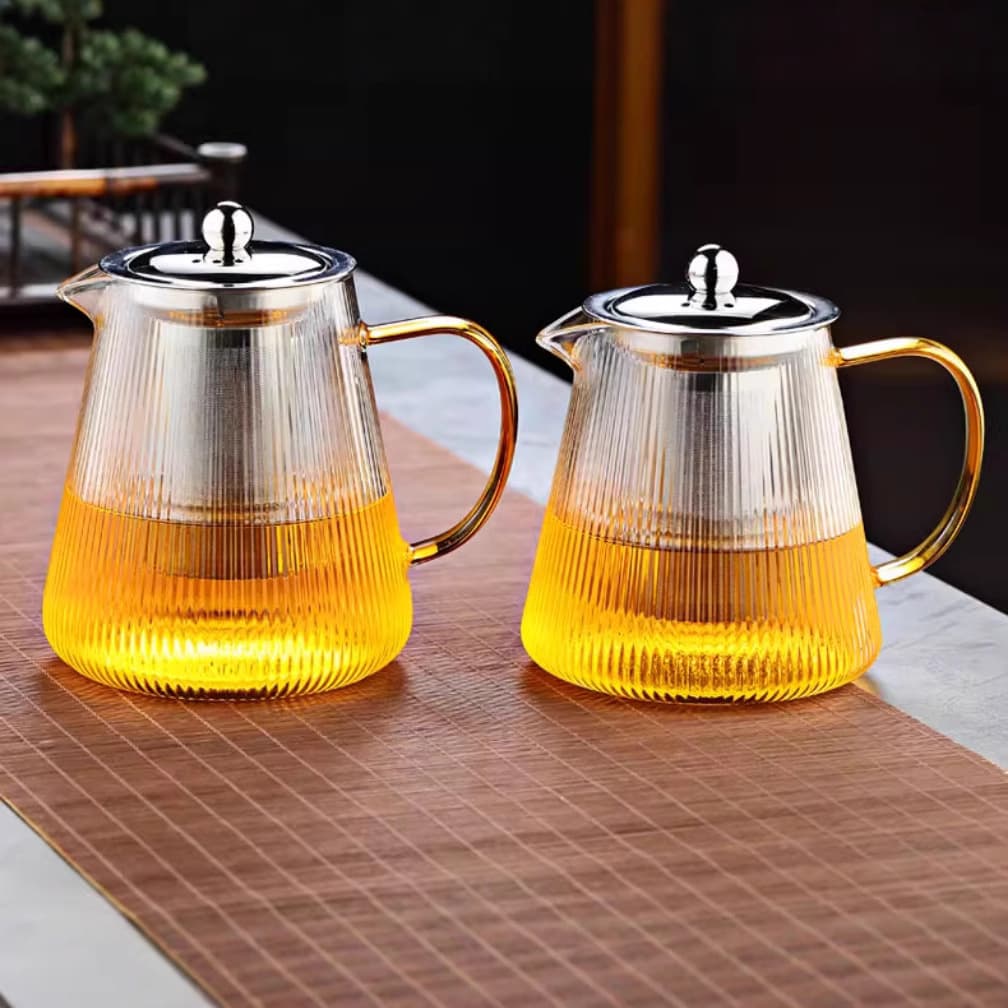 Heat-resistant glass teapot with striped steel infuser for brewing tea, Gongfu tea set including teapot and cups, thickened and explosion-proof for home use and entertaining guests.