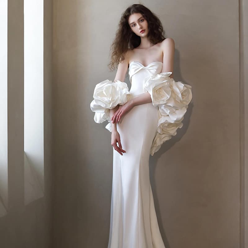 French travel photography light wedding dress with floral details, simple mermaid style, high-end white satin gown for bridal exit, dinner party