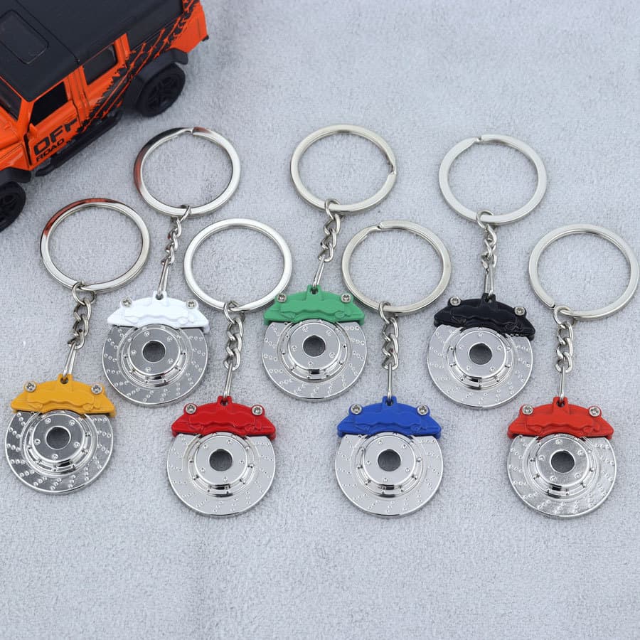 Factory ready rotatable brake pad keychain zinc alloy car keychain pendant with engraved LOGO small gift