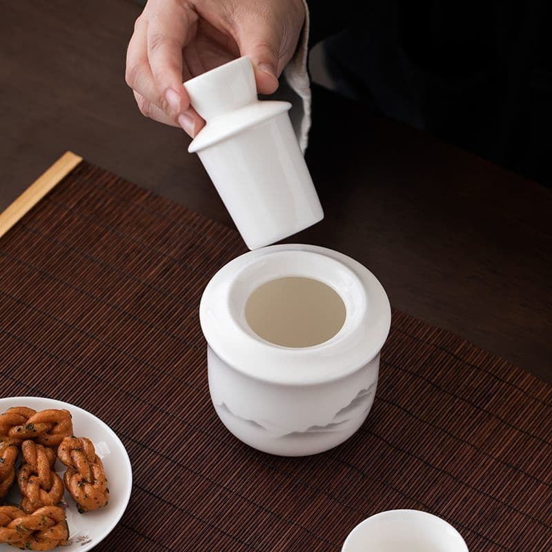 Dehua white porcelain wine warmer set, traditional Chinese yellow rice wine heating kit with blue-and-white cups.
