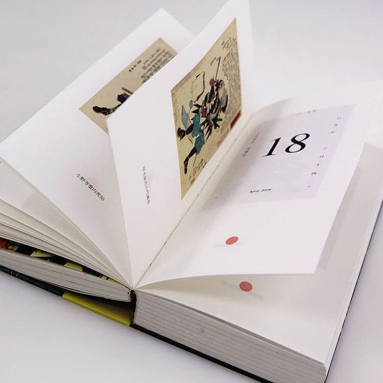 Exposed spine calendar printing, cloth-wrapped back desk calendar customization, hardcover book-style calendar production, 180-degree lay-flat design