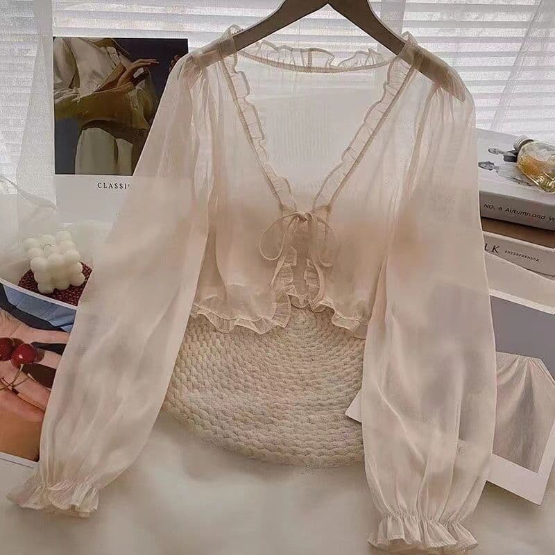 A short, fairy-like chiffon cardigan paired with a slip dress, perfect for summer student sun protection.