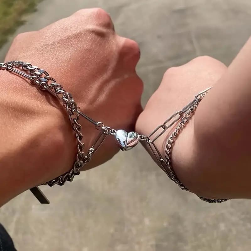 Titanium steel interlocking magnetic heart-pair bracelets for couples, attraction-themed non-fading unisex jewelry gifts.