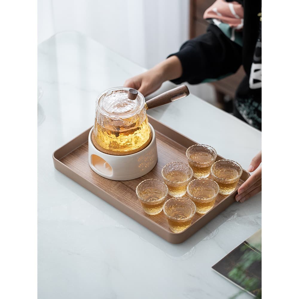 A luxurious rose teapot with candle heating base, electric ceramic stove for brewing tea, and afternoon tea set for beauty salons.