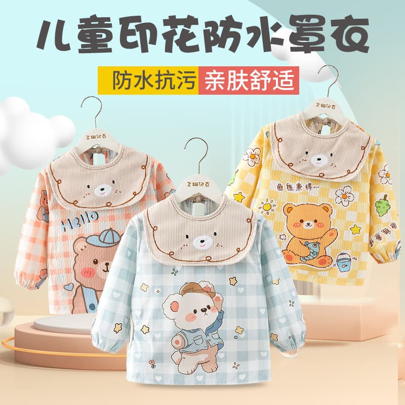 Corduroy children's smock for autumn/winter with long sleeves, waterproof bib and reverse wear design