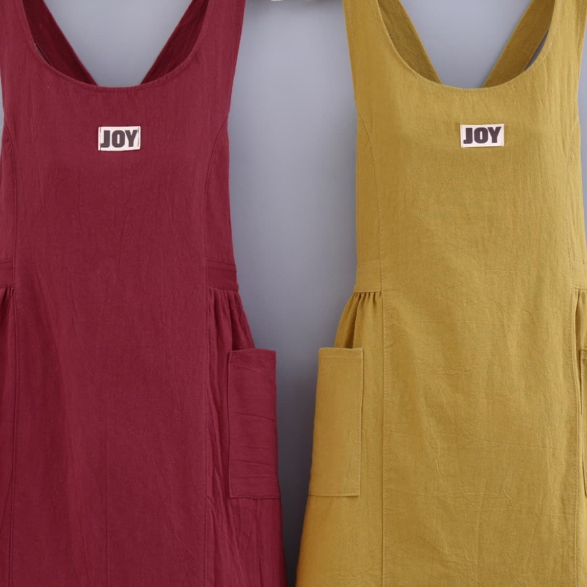 Stylish cotton apron for women, suitable for kitchen and home use, loose fit, cross straps, youthful and fashionable, durable and stain-resistant, Korean style workwear.