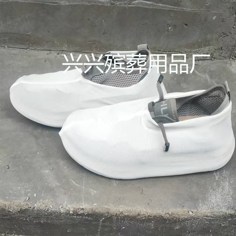 Disposable non-woven fabric shoe covers for funeral and mourning purposes.