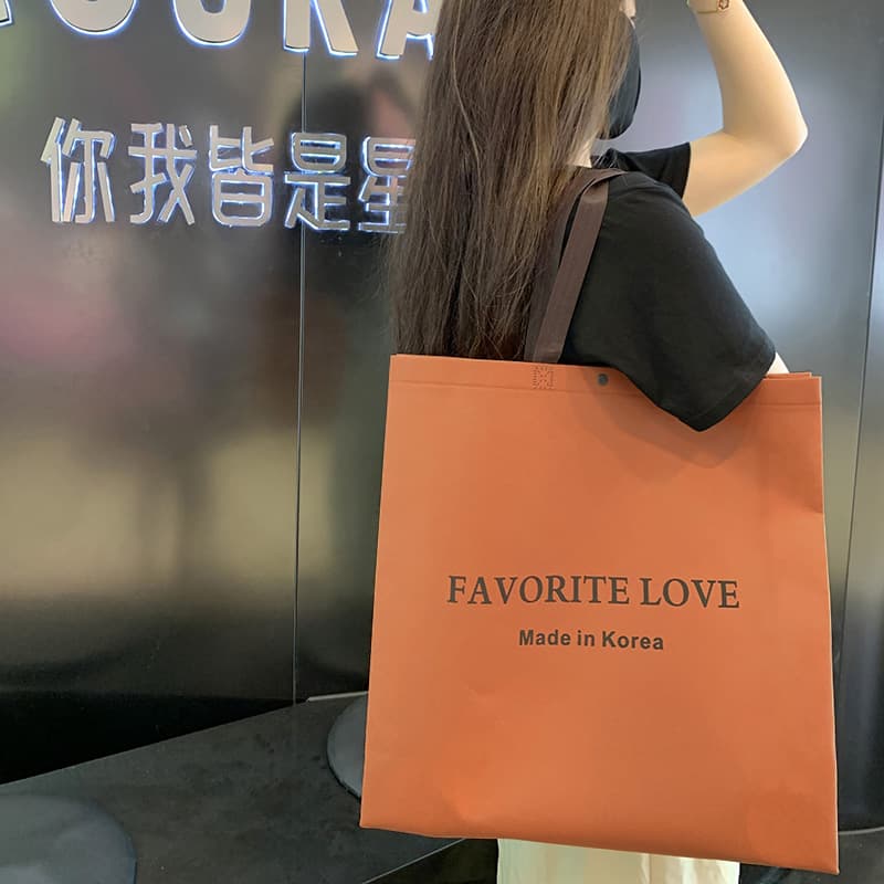 Custom non-woven handbag for trendy women's clothing store with hidden snap closure, shopping bag, clothes bag, logo customization