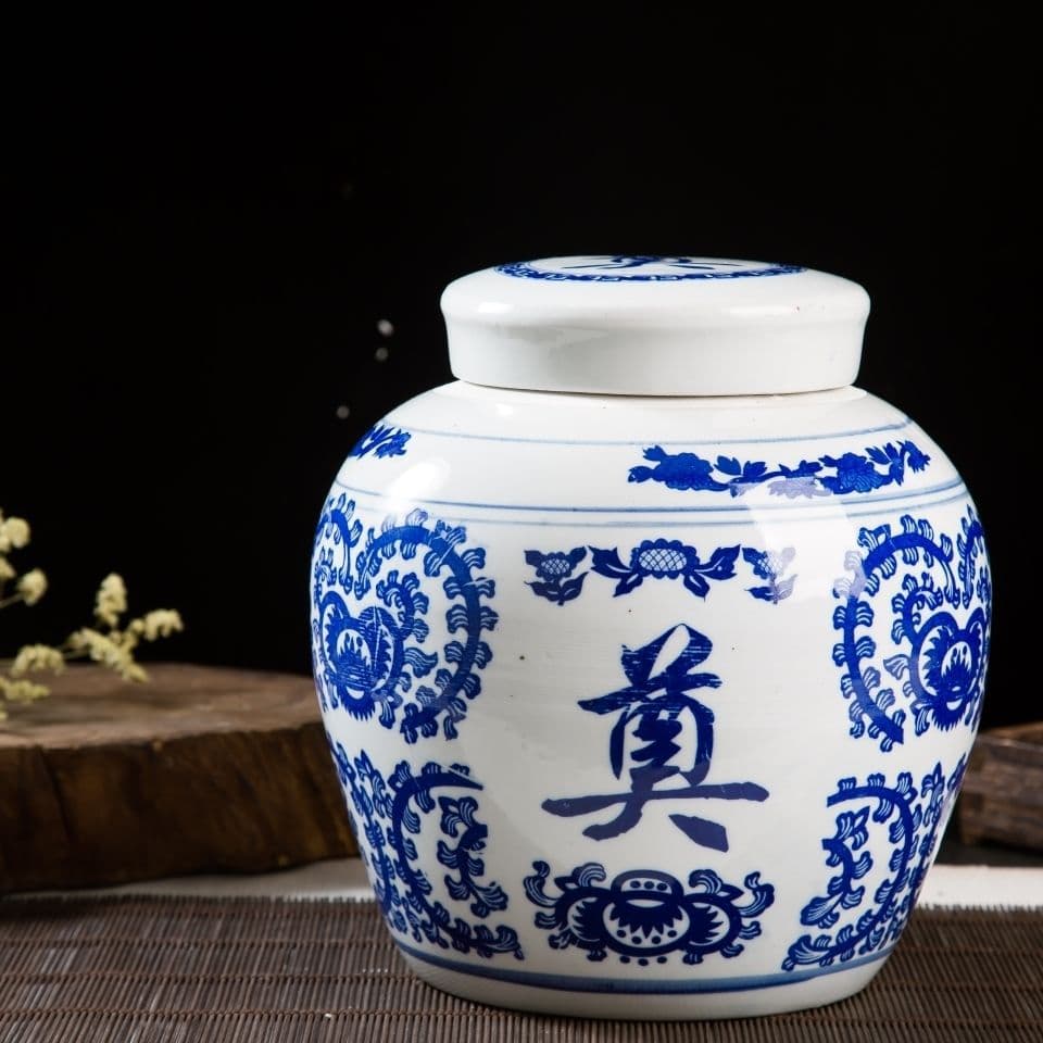 Large ceramic cremation urn with lid for bone collection, used in funeral industry and grave relocation.
