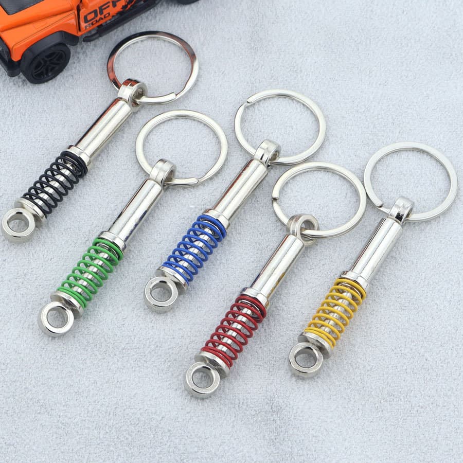 Factory Large Stock Metal Car Creative Shock-Absorbing Keychain Multicolor Spring Pressable Rebound Keychain