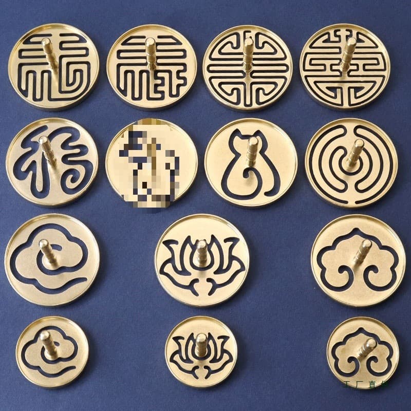 Copper incense seal set for stamping and spreading ash, with sandalwood and agarwood powder, mold, and burner.