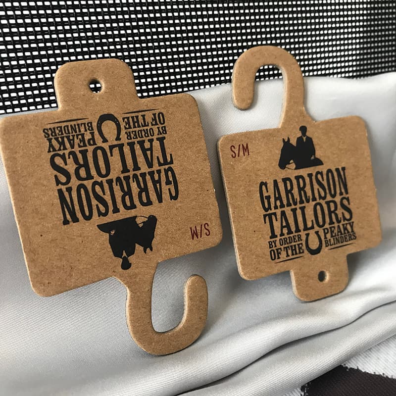 Shoe and sock packaging labels with round holes, hook holes, kraft paper towel hooks, and wholesale clothing product display hooks.