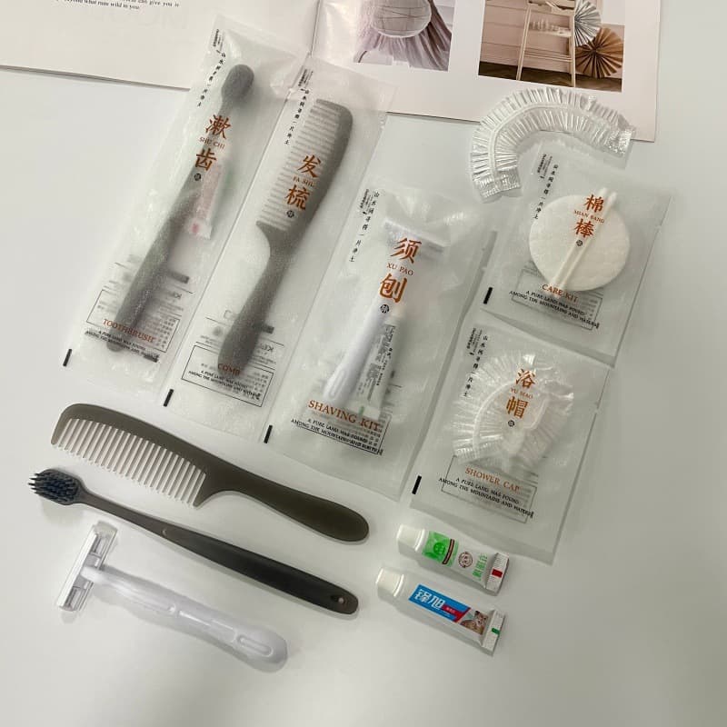 Manufacturer-supplied disposable hotel toothbrush sets with three-sided sealed packaging for accommodations