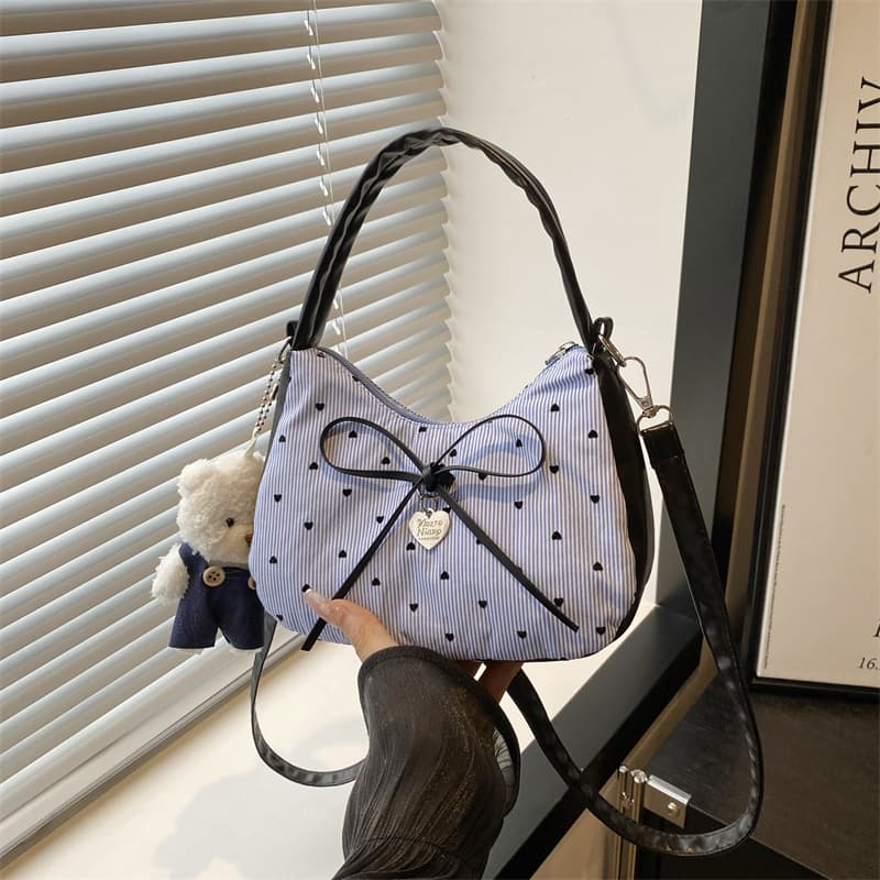 Niche contrasting color women's bag 2025 new sweet bow crossbody bag fashionable sweet and cool hot girl portable crescent bag