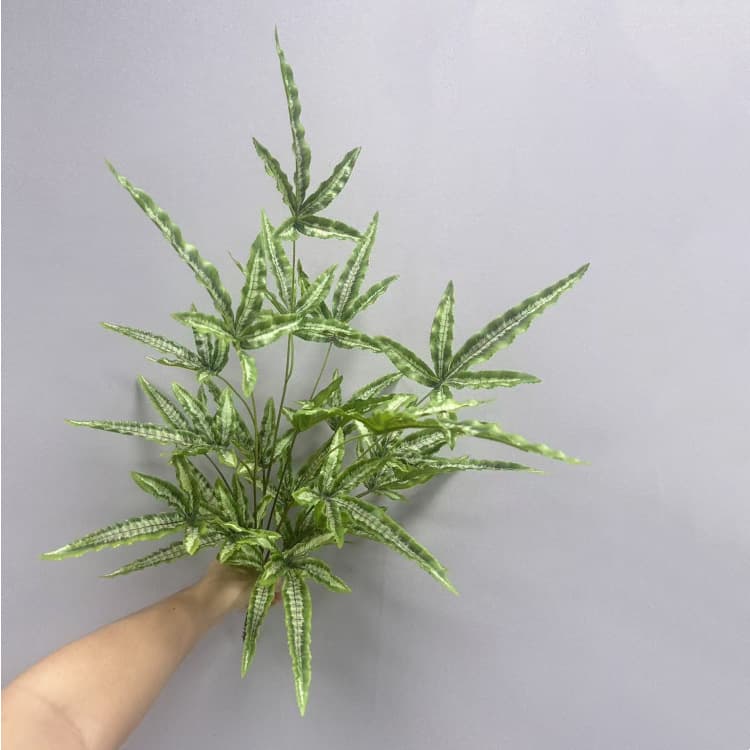 New artificial green plant with green golden fern leaves, perfect for indoor forest-themed wedding decorations.