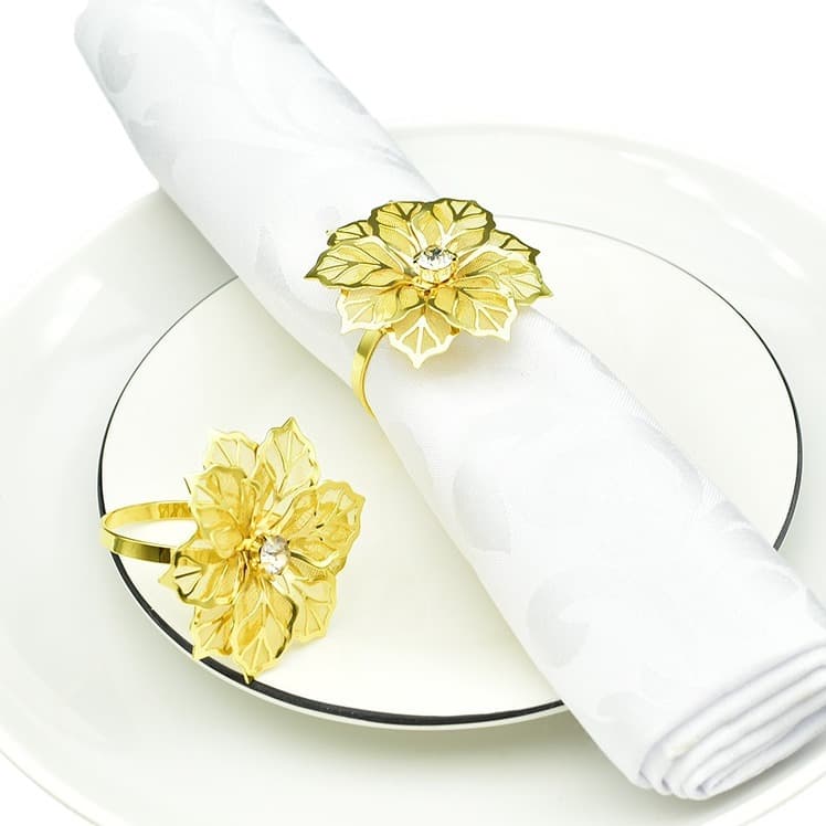 In stock: Gold mesh floral napkin rings for hotel tabletops, napkin clips, and yellow rhinestone-encrusted flower napkin rings.