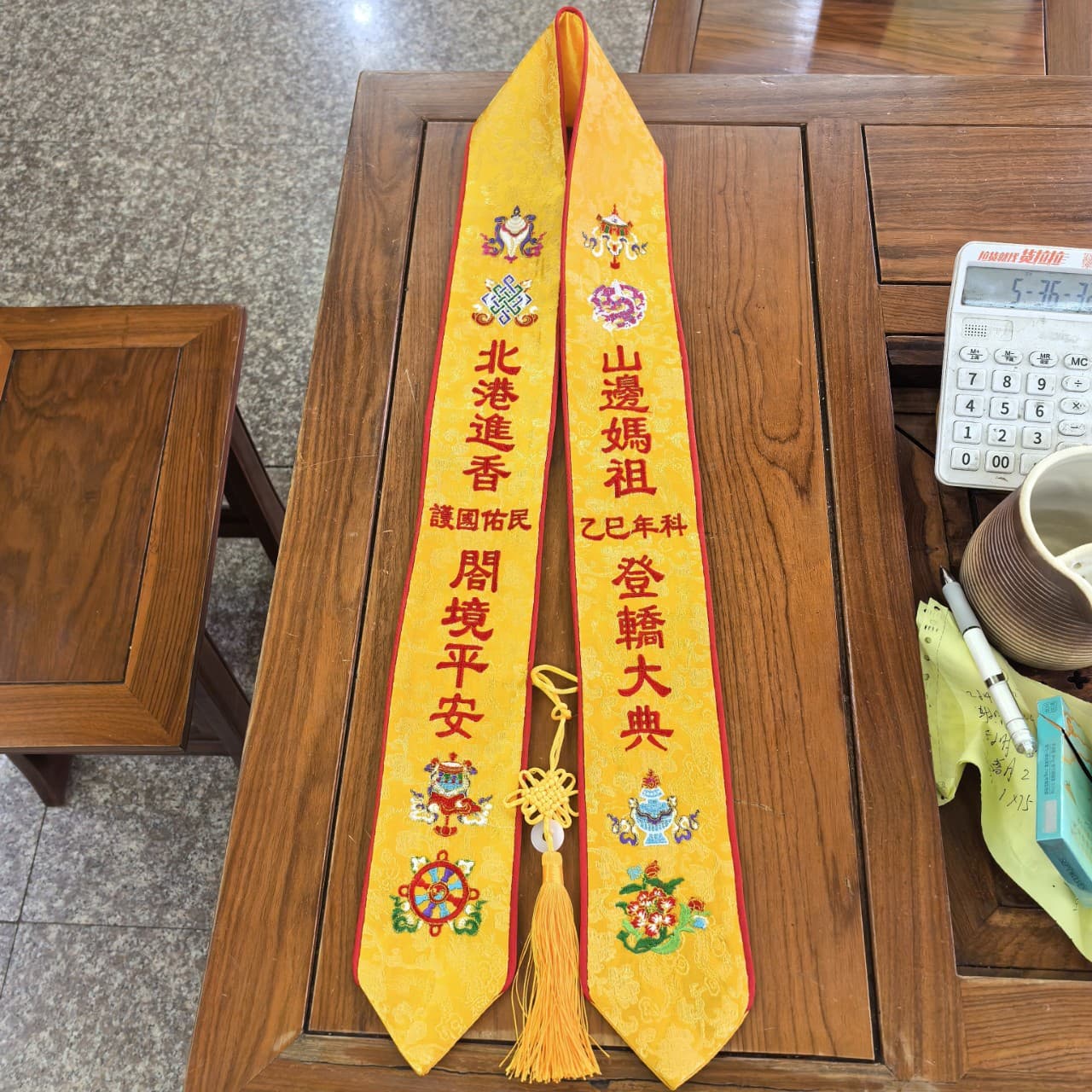 A large supply of cultural puja supplies, merit officiant belts, prayer belts, merit ribbons