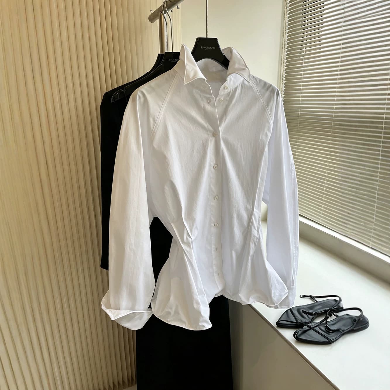 Stylish French-style elegant aluminum pleats with a shapely hem and a waist-cinching white shirt