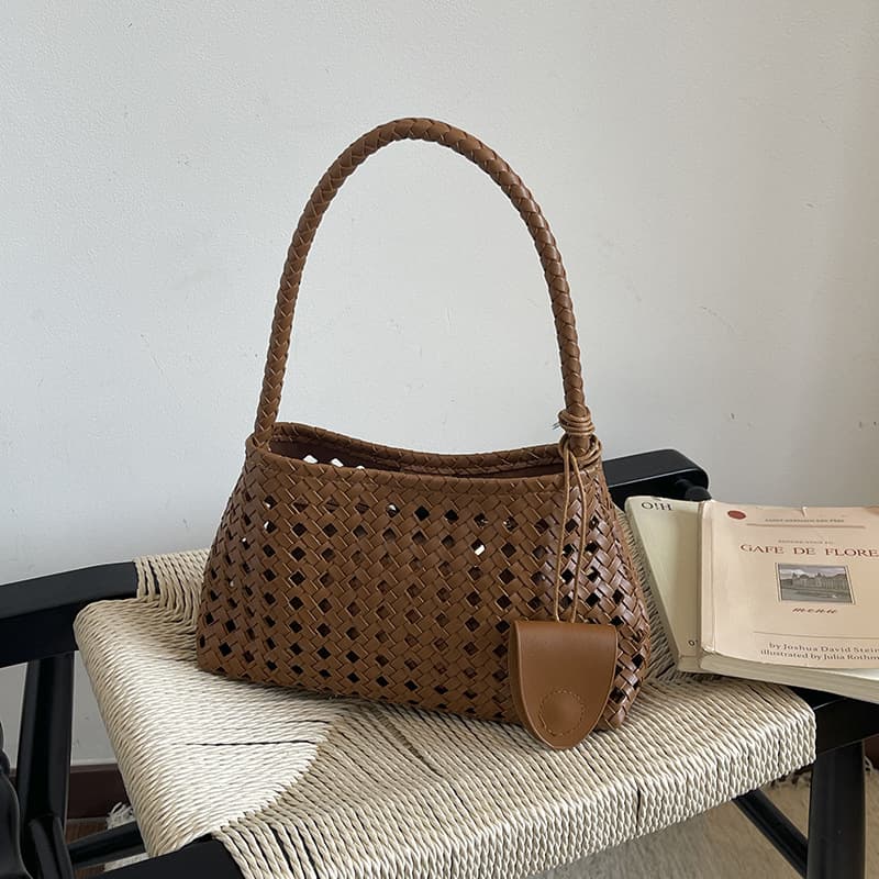 Cross-border niche design hollow armpit bag for women 2026 new style high-end foreign style commuting hand-carried woven bag