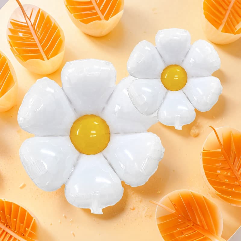 Daisy and sunflower foil balloons for birthday party decorations, large, medium, and small frangipani flower ground balloons.