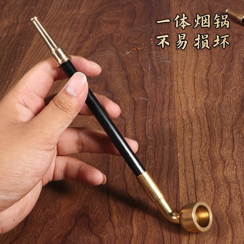 Old-fashioned traditional brass pipe for men's dry tobacco pipe, with extended brass mouthpiece, pipe for smoking pipes and tobacco.