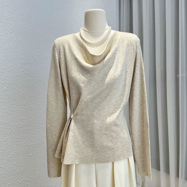 Plus-size, uniquely designed long-sleeved knit top for women, perfect for autumn and winter, with a flattering silhouette and asymmetrical waist.