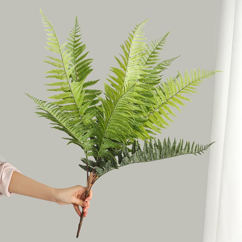Forest-themed wedding decorations featuring artificial ferns and grass; indoor artificial plant wall decoration with 12 large fern leaves.