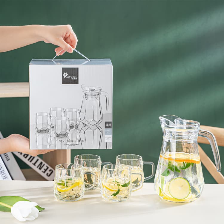 Glass cold water pitcher with diamond design, household set for cooling boiled water and cups.
