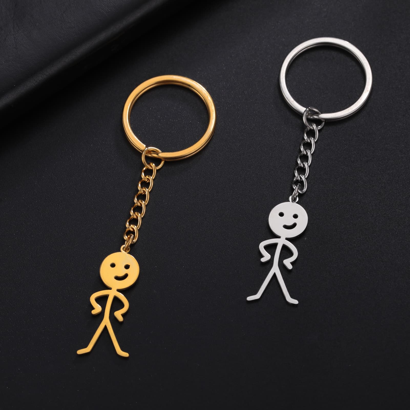 Factory direct sales wholesale source of supply cute titanium steel cut glossy akimbo villain pendant stainless steel keychain