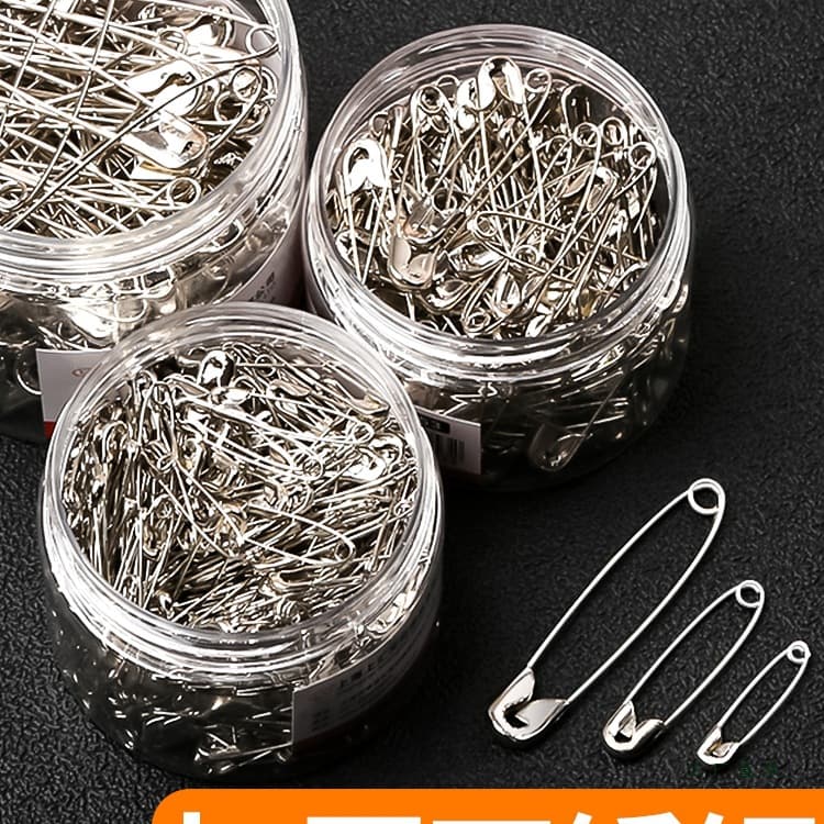 Vintage safety pins for securing clothing, available in small/large/extra-large sizes, also used as paper clips or bed sheet fasteners.