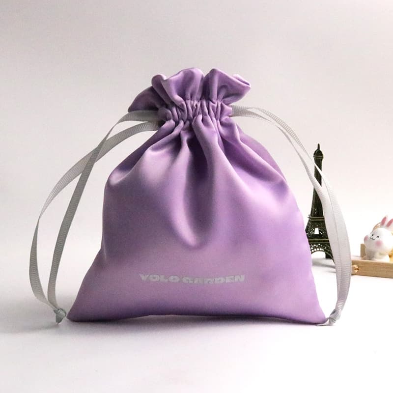 Manufacturer bulk supplies high-quality satin drawstring bags for jewelry, skincare products, and storage, customizable with logos.