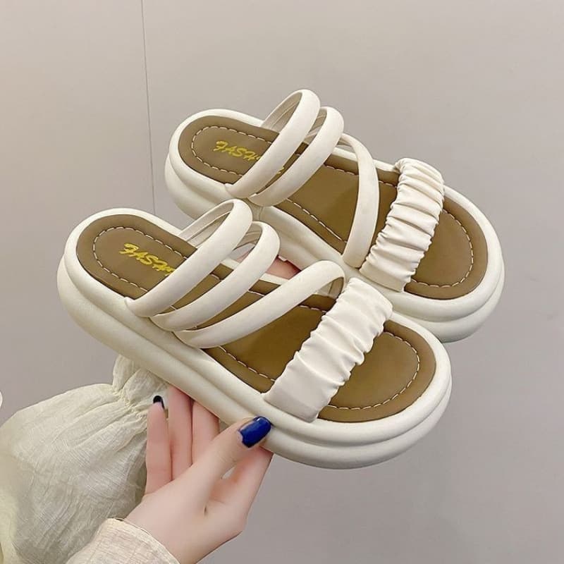 Slippers, providing warm care for your feet. Beige and black, closed-toe, adult, in-stock, casual.
